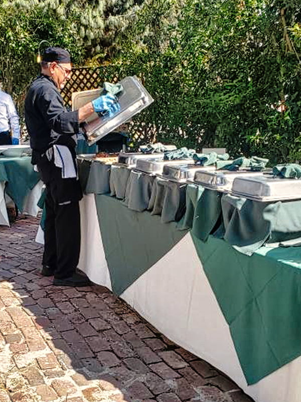 Cisco's Mexican Restaurant: A man is preparing Mexican food on a table in a garden for a catering event during Happy Hour.