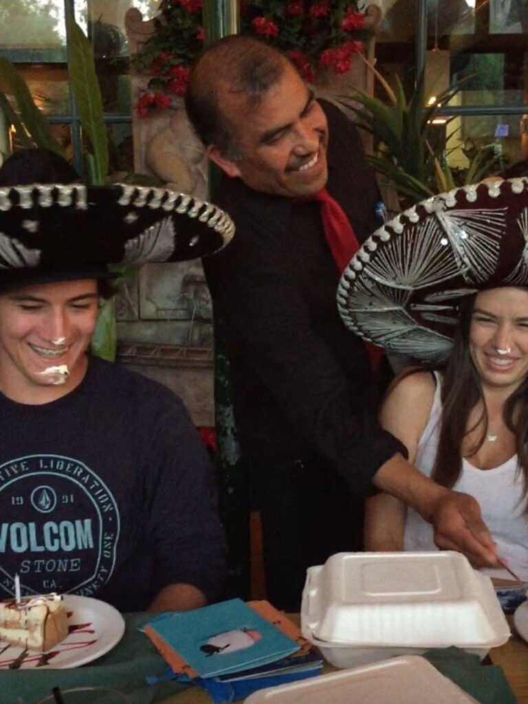 Cisco's Mexican Restaurant: A man serving Mexican food to guests wearing sombreros.