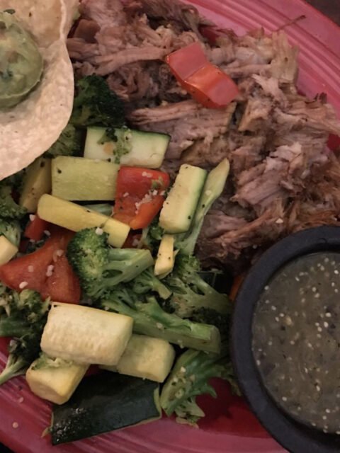 Cisco's Mexican Restaurant: A plate of carnitas Mexican food with vegetables and guacamole on it.